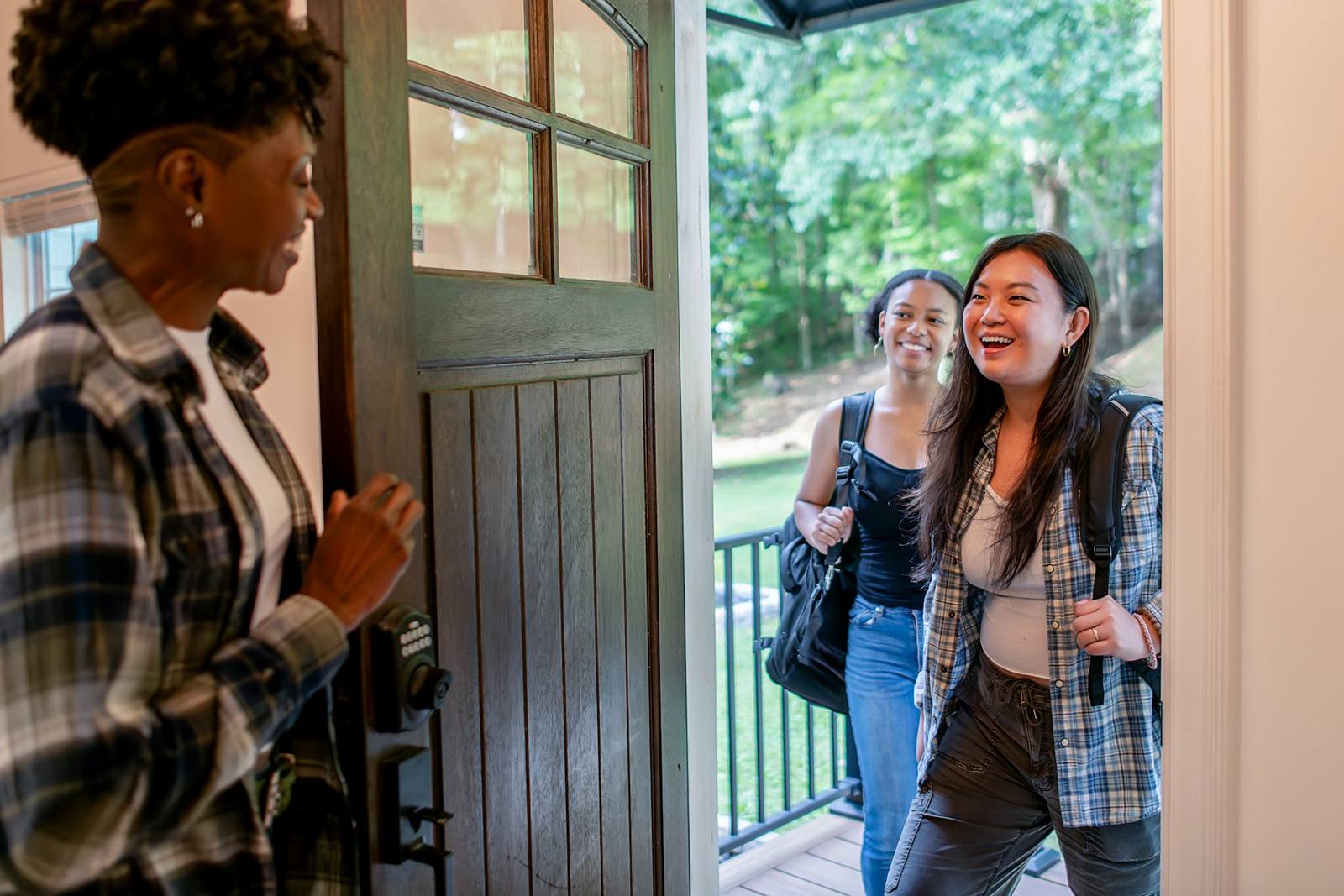 Neighbors greeting each other at a front door