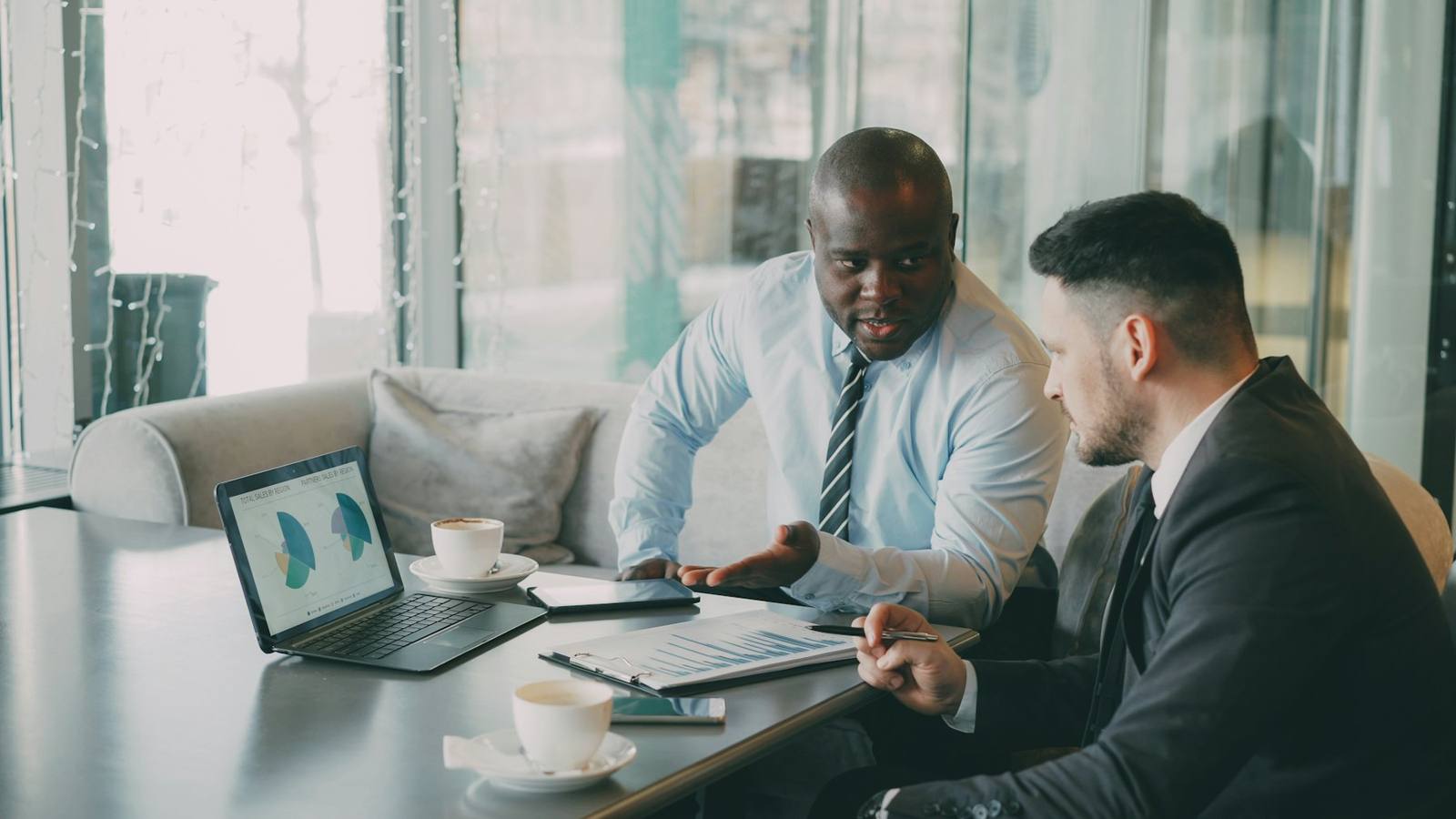 Mentor and team member working at a laptop