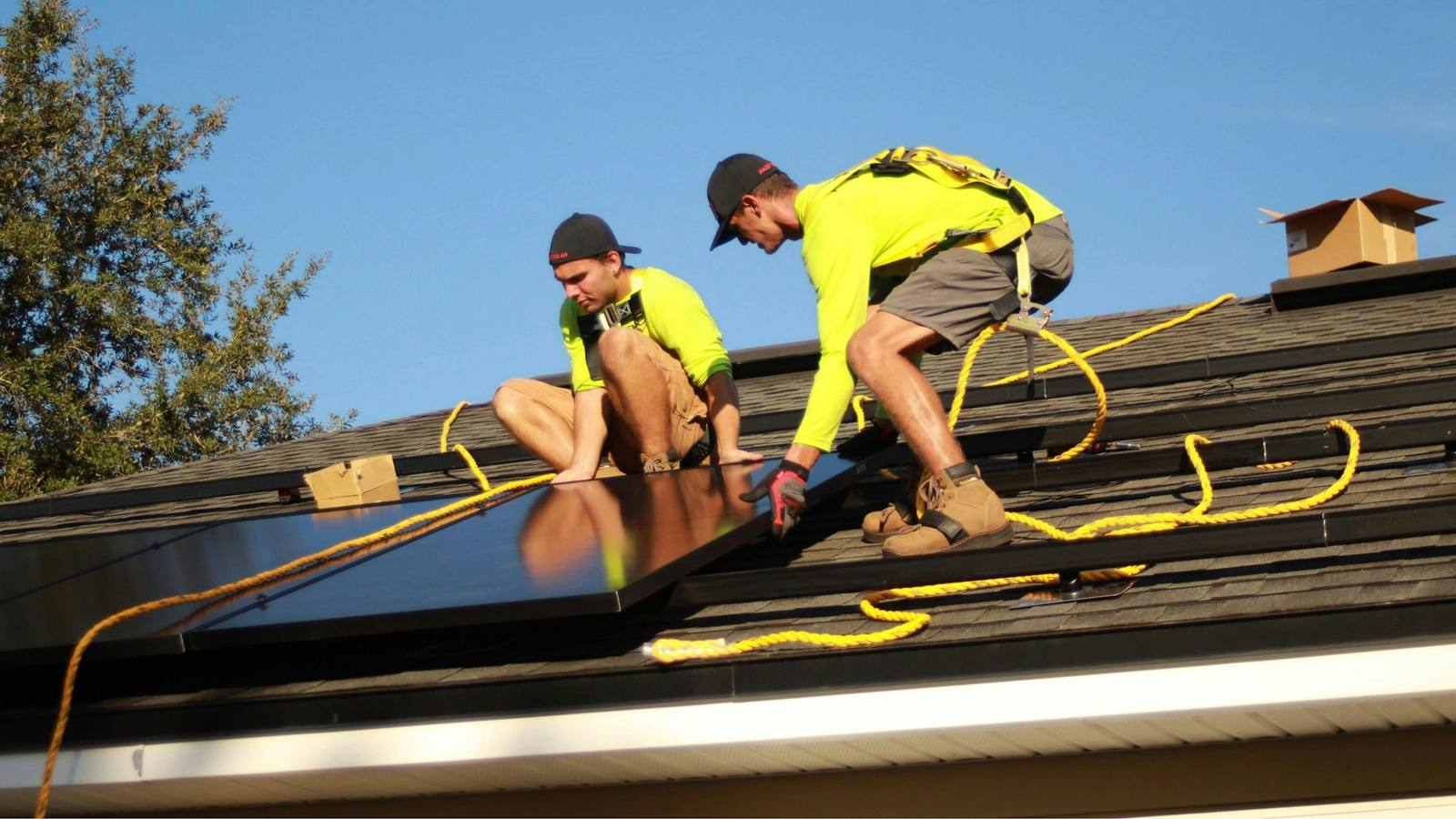 Crew installing solar panels on a roof